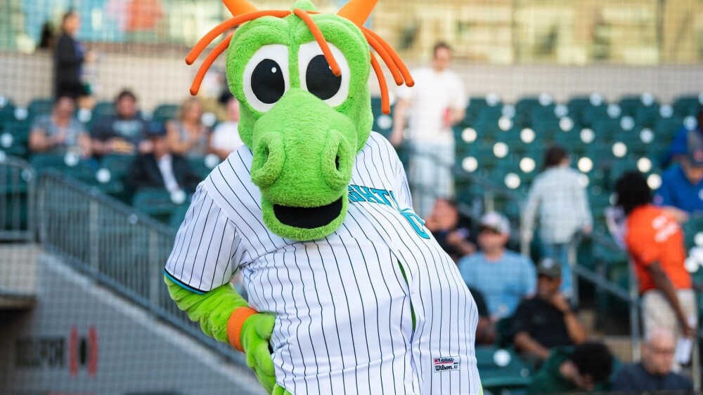 The Charlotte Knight's mascot Homer the dragon poses for a photo in the stands of Truist Field.