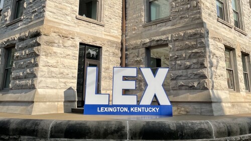 sign outside of an old stone building