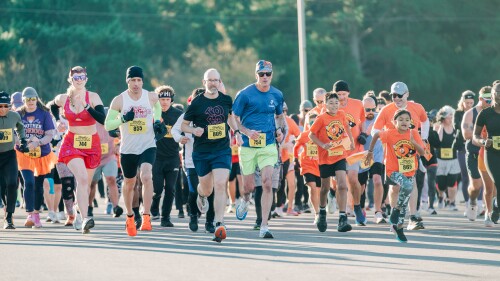 A group of people racing at the Pumpkin Run.