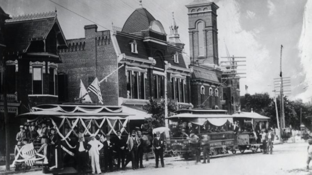 People gather on a street in 1889 as Nashville's first electric streetcar is debuted.