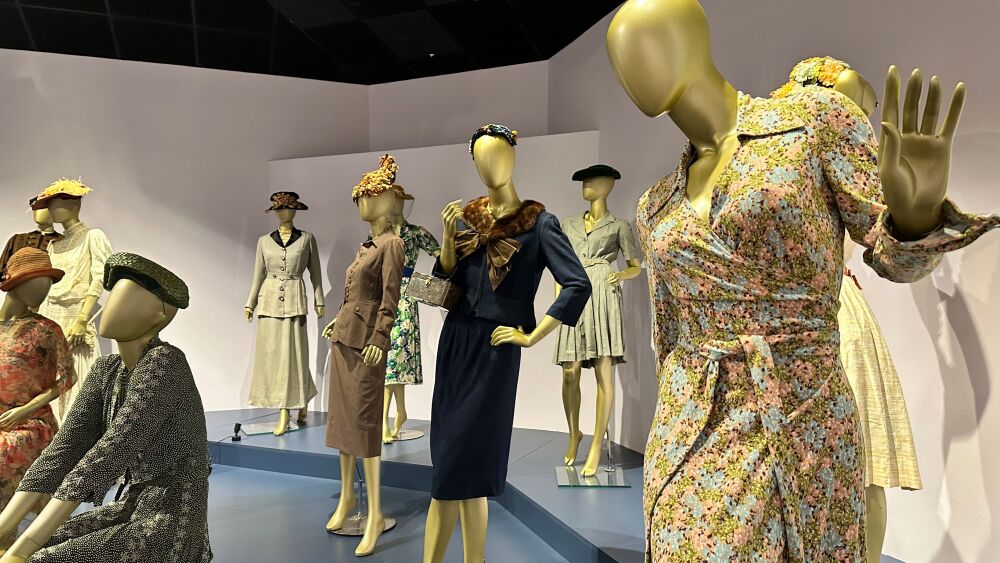 Mannequins on display are clothed in historically fashionable outfits.