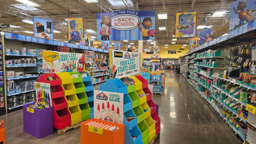 The interior of a Kroger showing the back-to-school aisle filled with brightly colored displays.