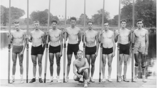 A black and white team photo shows the athletes on the UW Rowing team that led the US to a gold medal in the 1936 Berlin Olympics.