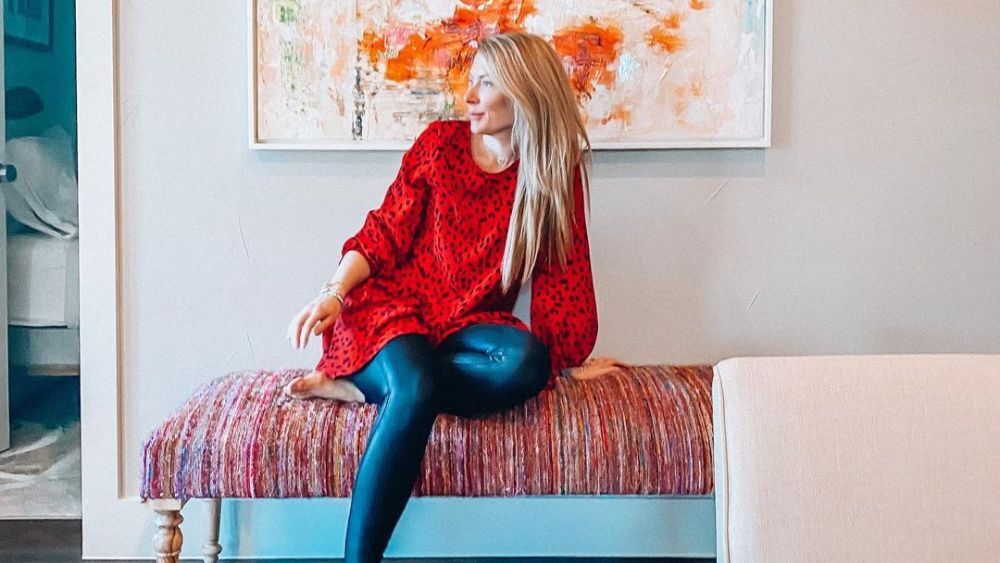 Austin-based influencer Erin Ruoff sitting on a colorful bench in her home.