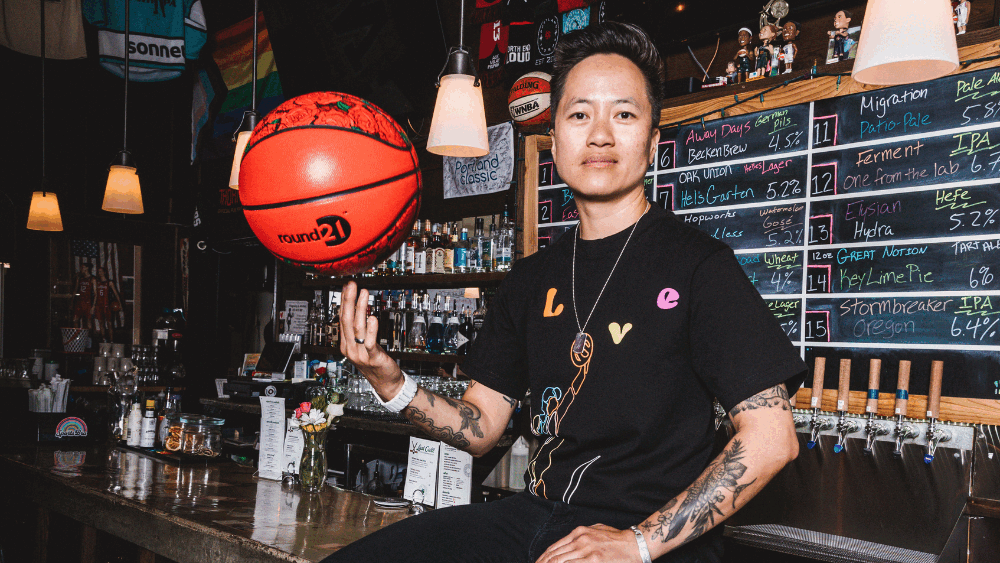 Alternating images show Jenny Nguyen, owner of The Sports Bra, spins a basketball on her finger while sitting on the bar top. The second image shows young girls holding signs about their excitement for a WNBA team coming to Portland.