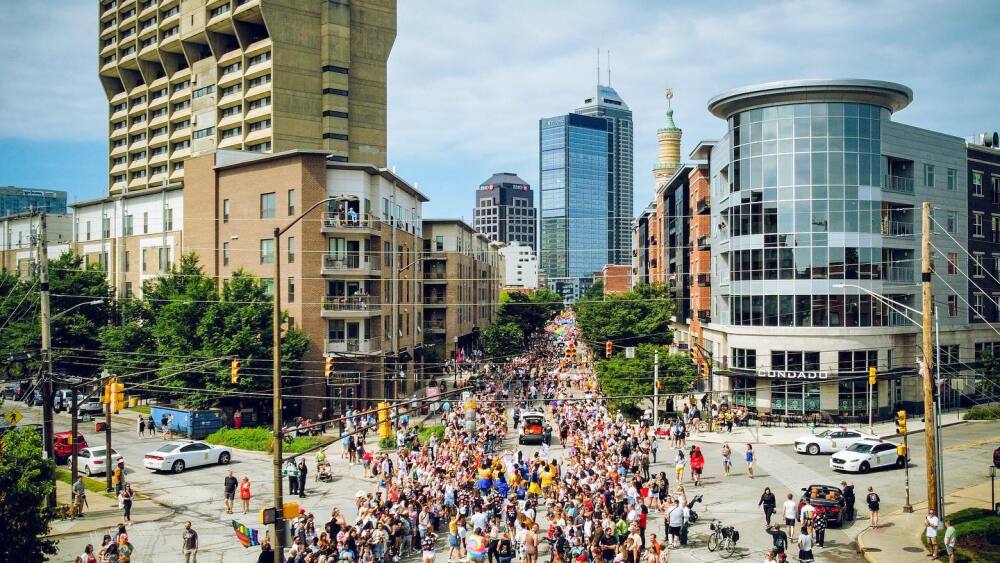 A parade of people along Mass Ave. for Pride Fest