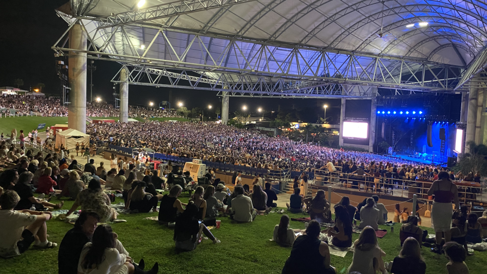 A crowd watches on at the MidFlorida Credit Union Amphitheatre. Lana del Rey is playing soon and the sky is dark.