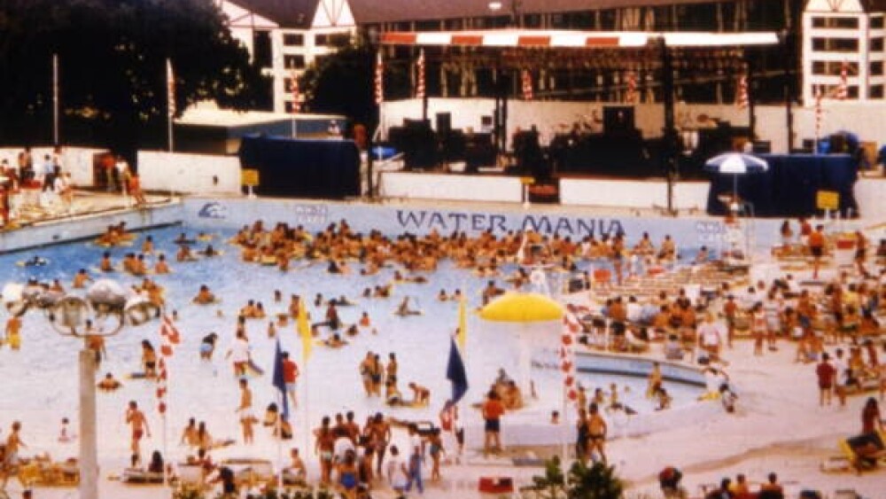 Hundreds of people in a large pool circa 1980s