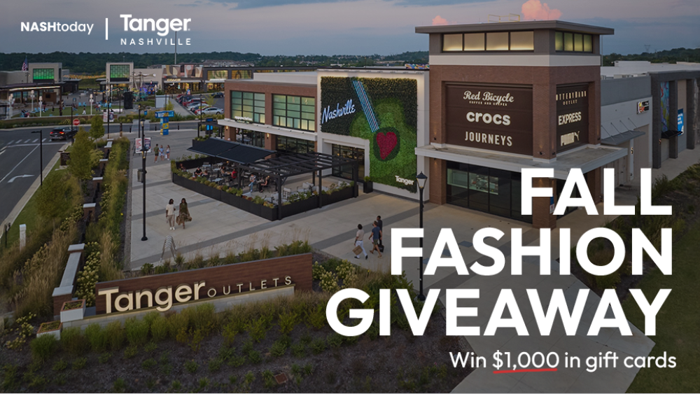 Tanger Outlets in Nashville at dusk with people walking and dining outside. Overlay text reads "Fall Fashion Giveaway" offering $1,000 in gift cards.
