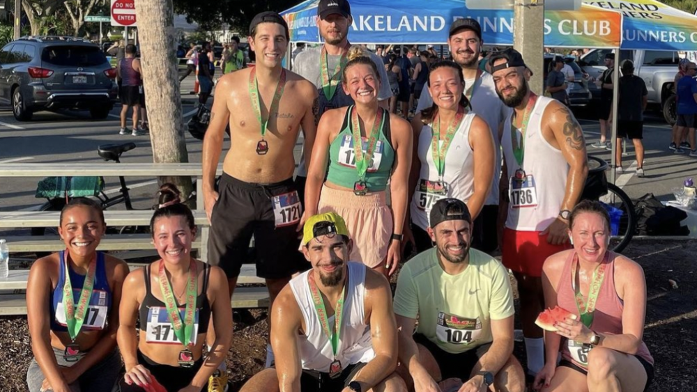 A group of men and women pose after a race