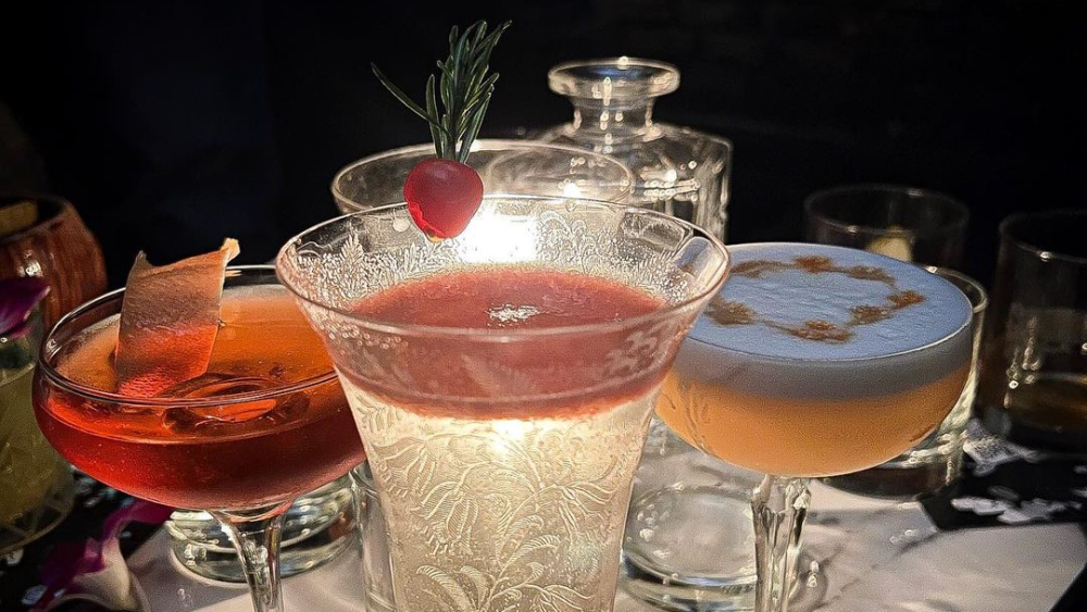 Three cocktails lined up on a table at Midnight Cowboy