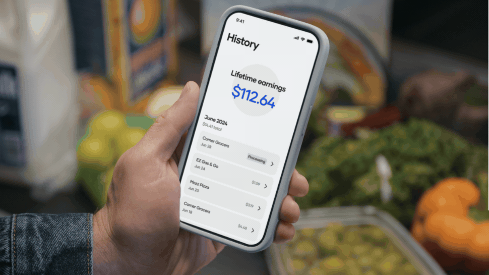 A person holding a phone at a grocery store and gas station with the Upside app open.