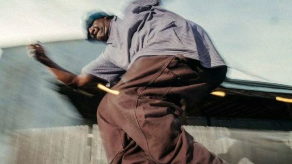 A man rollerblades on a handrail.