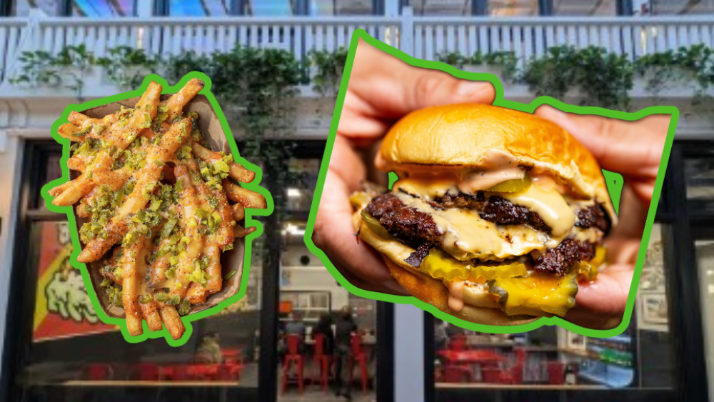 A blurred storefront in the background with a plate of loated fries and two hands holding a burger outlined in green in the forefront.