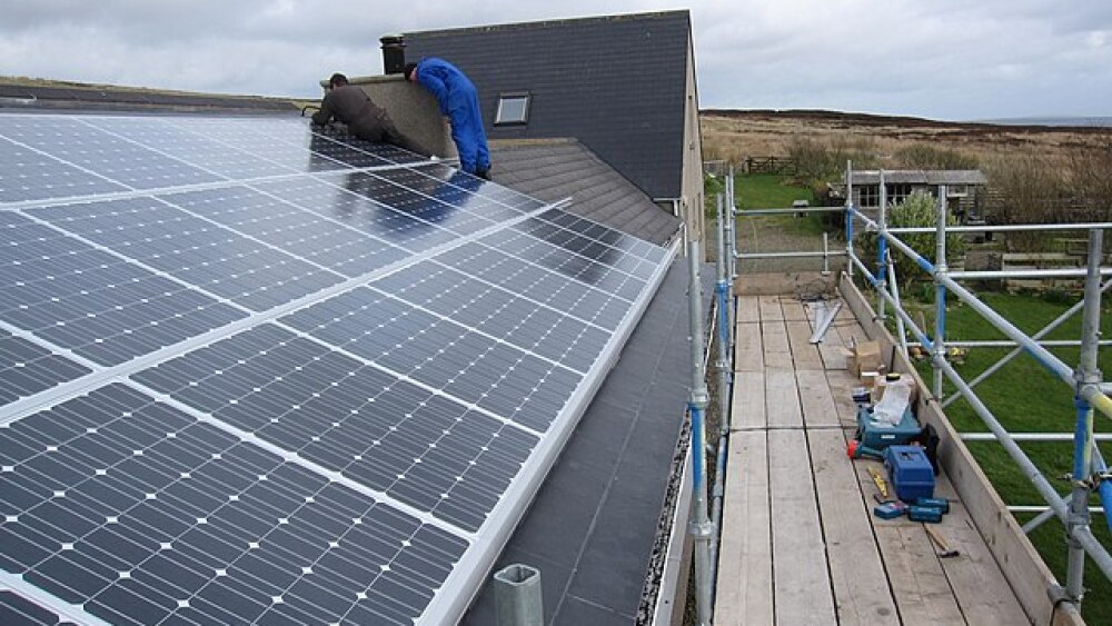 solar panels being installed on a roof