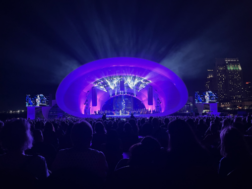 A shell-shaped concert stage glows in deep purple lights during a show in San Diego, California.