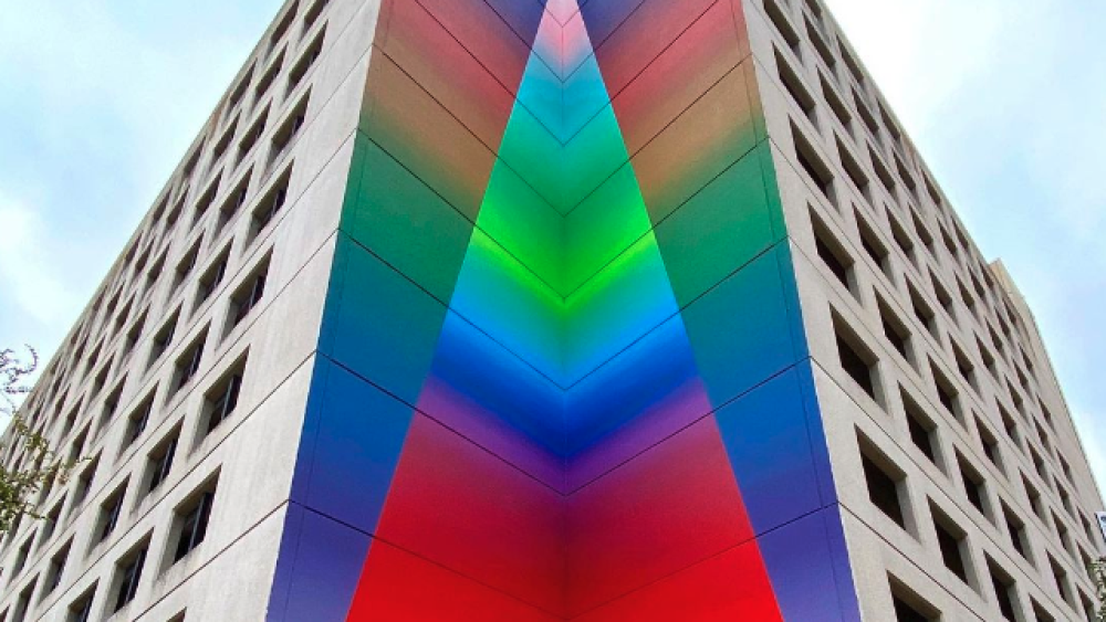 A spectrum of colors in the corner of a building.