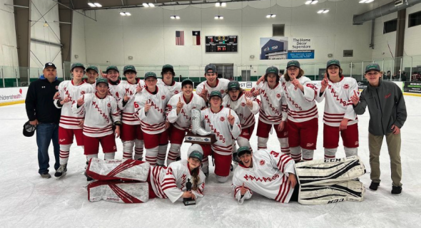 A hockey team of young men in white and red gear.