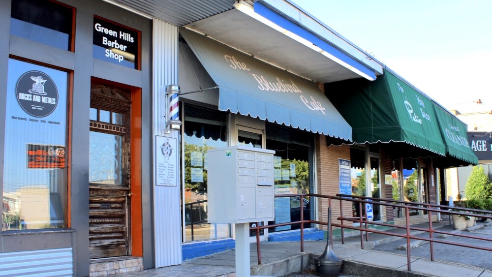 The exterior of The Bluebird Cafe with its famous light blue awning.