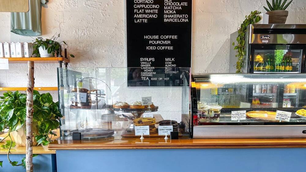 Coffee counter with menu and pastry case