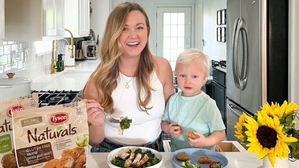 Austin influencer Natalie Paramore and her son eating chicken nuggets and fresh veggies.