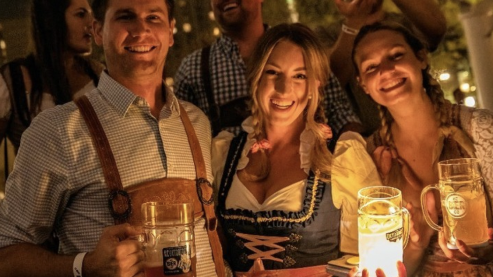Group of 5 people drinking beer at KC Oktoberfest celebration.