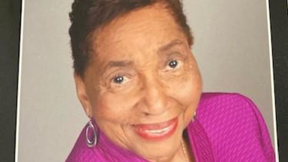 Lavon Marshall smiling and wearing a purple jacket.