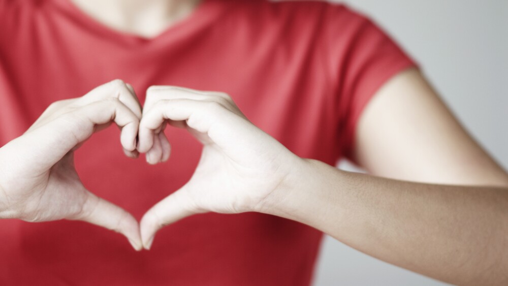 Woman Making Heart Shape with Hands