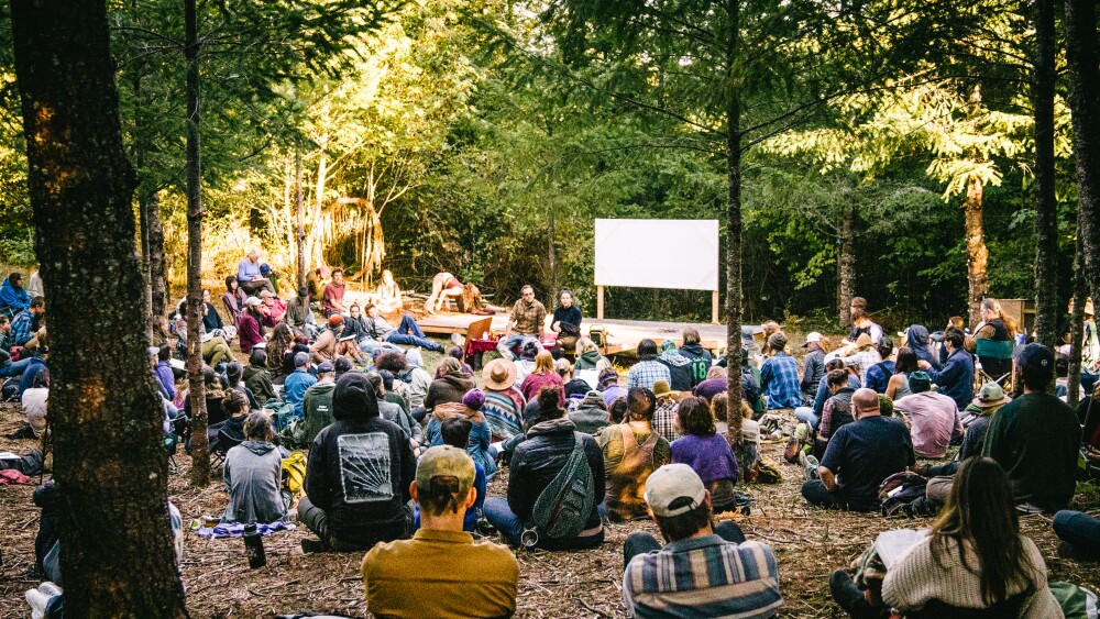 A group of people gather for an outdoor, educational session at Rad Myco.