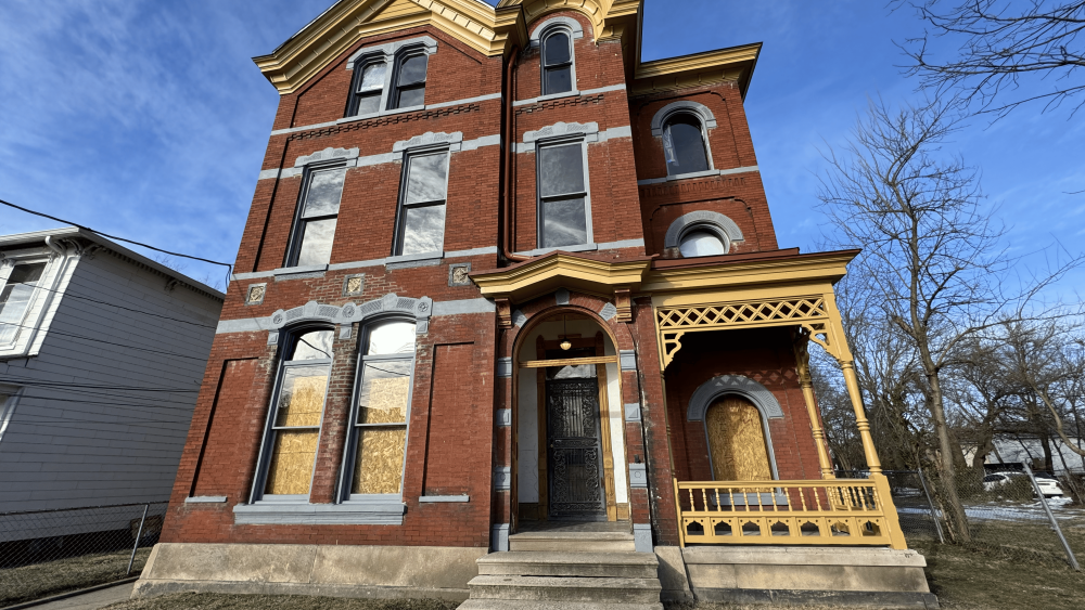The exterior of a red brick mansion in Louisville