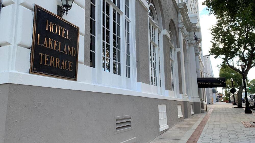 Photo on outside corner showing the hotel sign in front of the Terrace Hotel