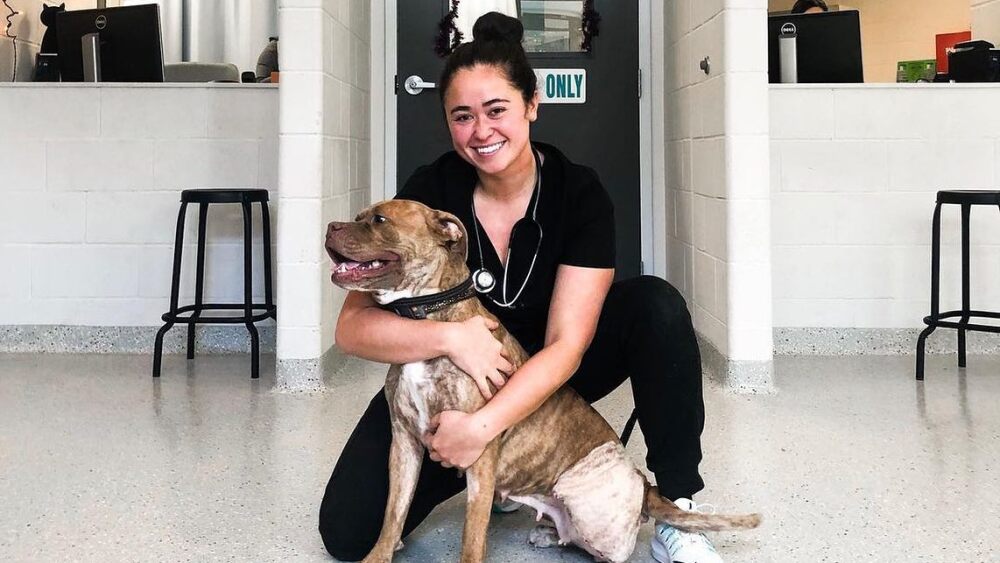 A person hugging a dog at Indy Humane