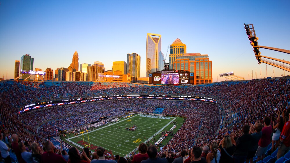 A packed Bank of America stadium with the Uptown skyline in the background.