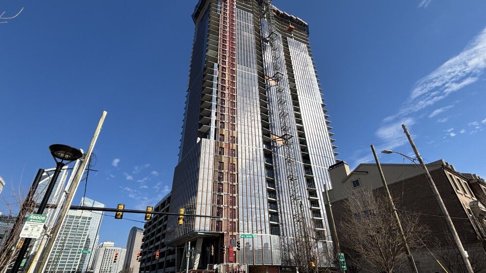 A tower under construction with the Charlotte Uptown in the background.