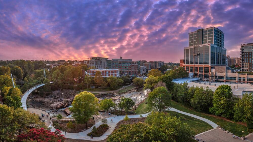 Purple/pink sunset over a wide angle view of Falls Park in Greenville, SC.