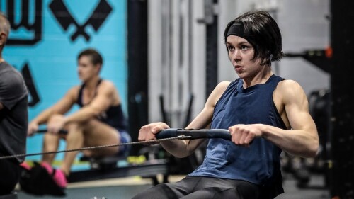 A person uses a rowing machine to workout.