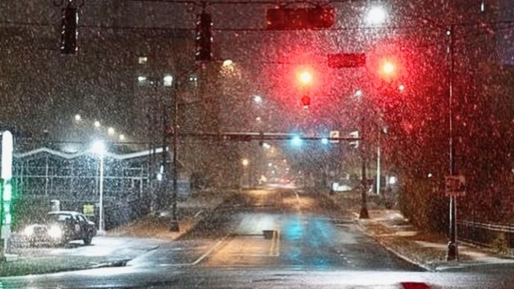 Snow in Winston-Salem at a traffic intersection. It's a flurry with minimal snow on the ground.