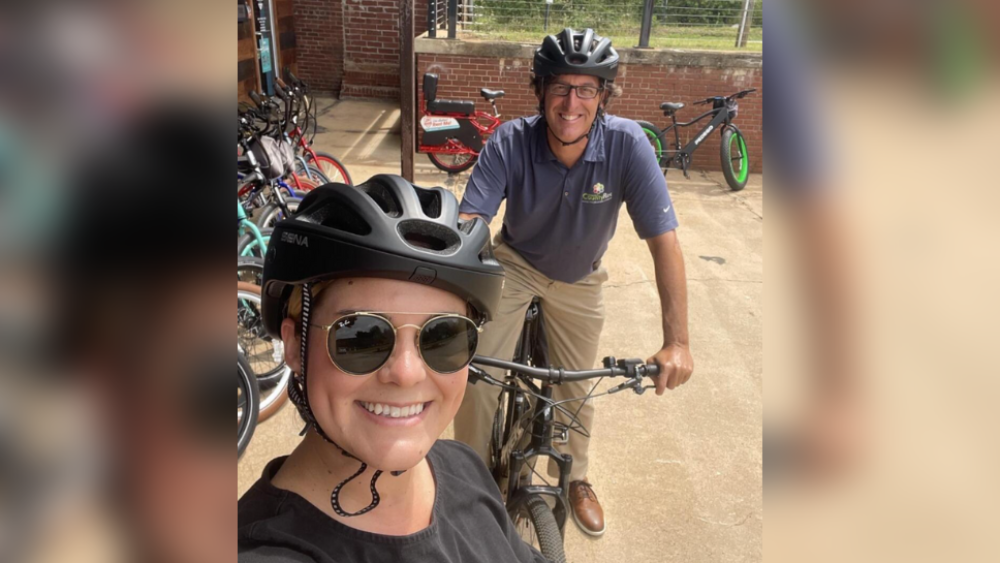 City Editor Kyle and Durector of Greenways, Natural and Historic Resources for Greenville County Parks, recreation & Tourism Ty Houck on electric bikes outside of Pedego in Greenville, SC.