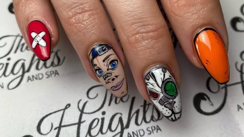 A close-up of a hand with pointed nails painted with realistic cartoon character designs.