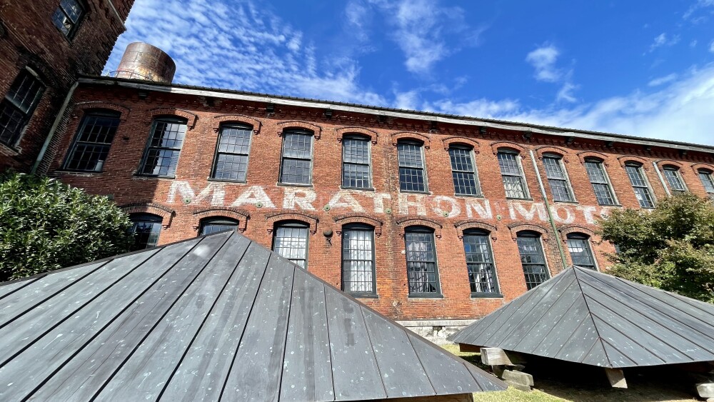 Marathon Motor Works is painted on the front exterior of a Marathon Village building.