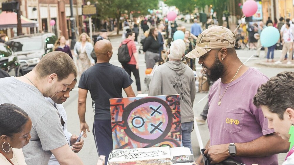 People shopping artwork at Art Crush on Trade Street in downtown Winston-Salem.