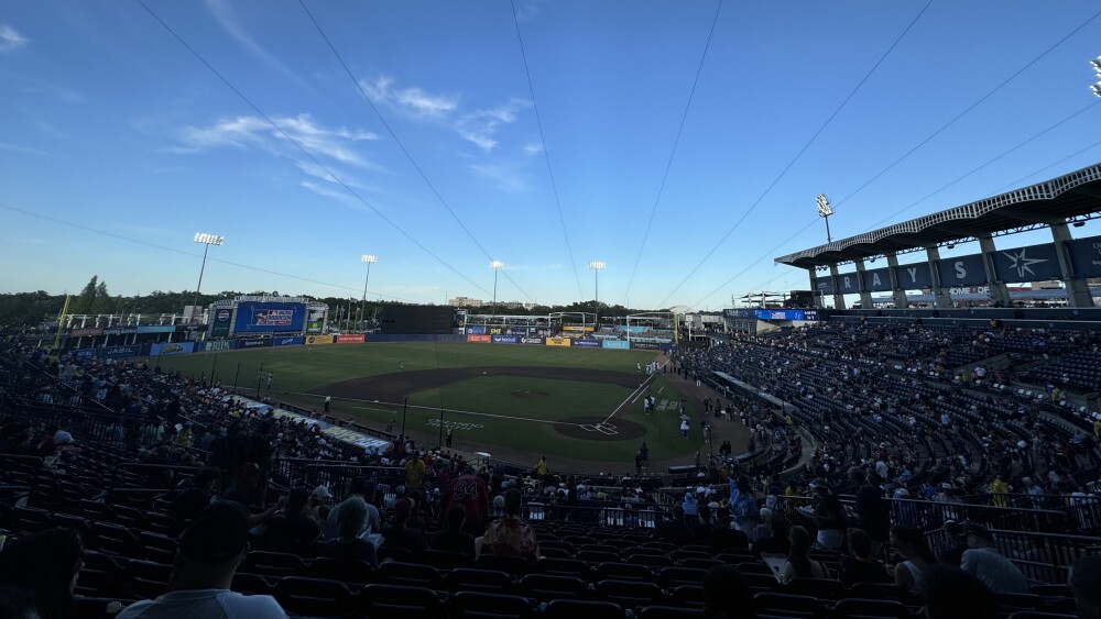 Looking out on the Rays playing the Red Sox at Steinbrenner Field under a blue sky with a few clouds.