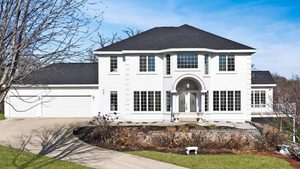 507 Riverside Drive, a three-story, white, colonial-style home