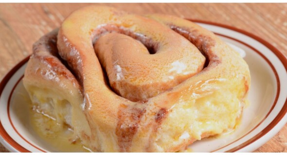 A close-up of a warm and buttery sweet roll.