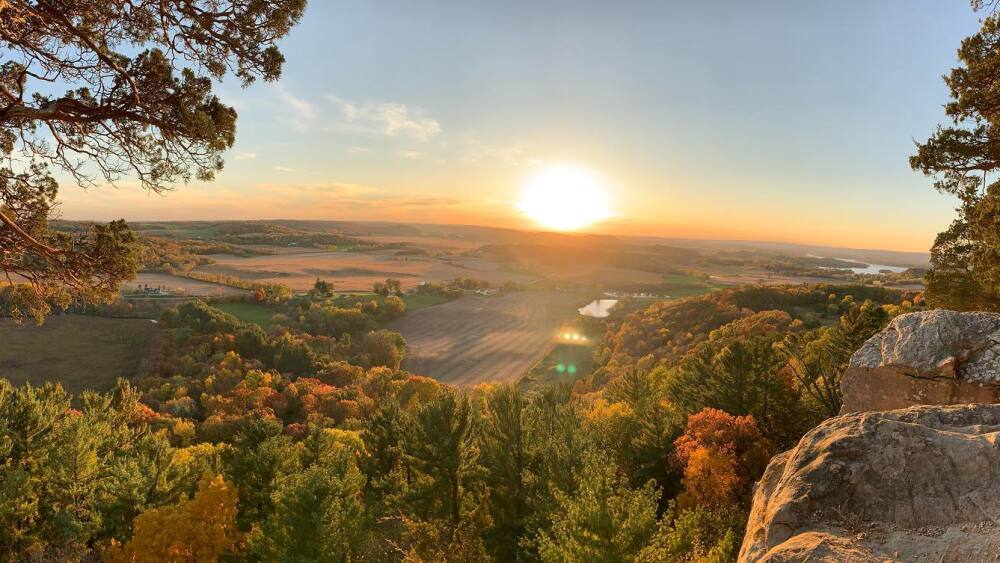 fall colors from hilltop, sunset on horizon