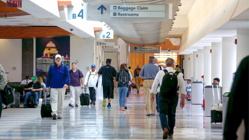 a shot of people walking through an airport terminal