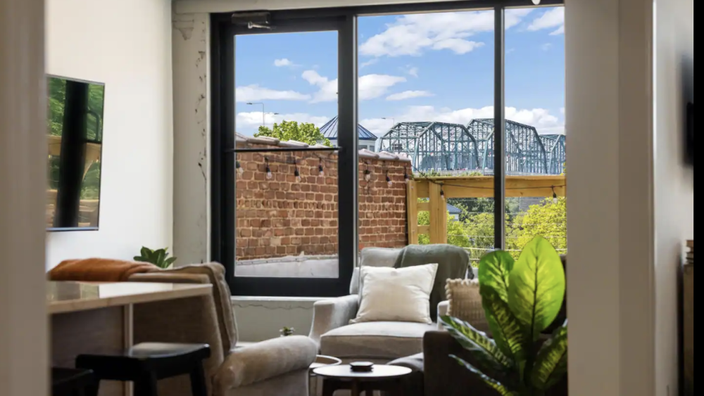 NOOGAtoday | Living room with views of the Walnut Street Bridge in the background.