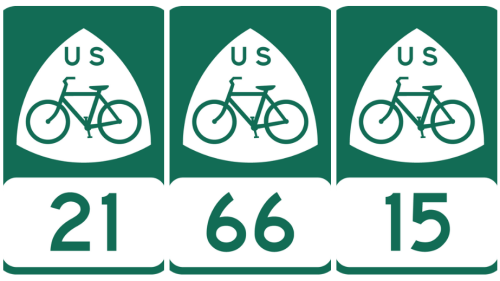 Three bike route signs lined up in a row. All of the signs are green and white and depict a bike under the letters "US," with a number below indicating which route it is.