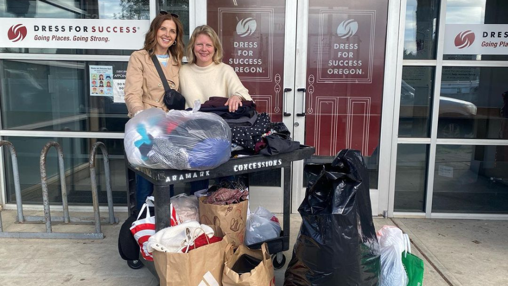 Volunteers with Dress for Success Oregon pose with bags of donated clothing.