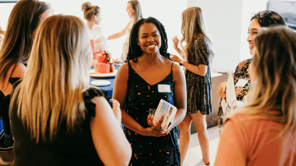 A GIF of attendees mingling at an Endeavor networking event.